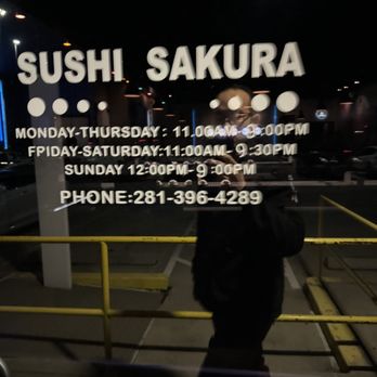 Sushi Sakura - a man standing in front of a sign - Conveyor Belt Sushi Near Me - Katy, Texas Sushi Sakura - a man standing in front of a sign - Conveyor Belt Sushi Near Me - Katy, Texas