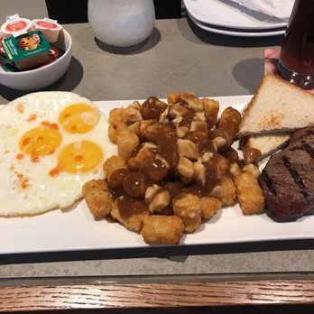 State & Main Kitchen & Bar - Steak & Eggs from the brunch menu with tater tot poutine - Bars Near Me - Etobicoke, Ontario State & Main Kitchen & Bar - Steak & Eggs from the brunch menu with tater tot poutine - Bars Near Me - Etobicoke, Ontario