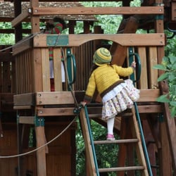 Rose Kindergarten - Children playing on the play structure in our oak forest!