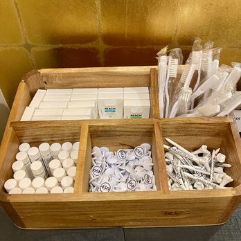 450 Aesthetics Dental Group - Tray offering complimentary dental floss, toothbrushes, branded lip balm, as well as branded golf ball markers and tooth-themed golf tees - General Dentistry Near Me - San Francisco, California 450 Aesthetics Dental Group - Tray offering complimentary dental floss, toothbrushes, branded lip balm, as well as branded golf ball markers and tooth-themed golf tees - General Dentistry Near Me - San Francisco, California