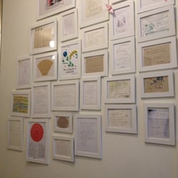 Old Town Lodge - Wall of framed thank you cards from guests