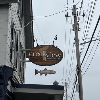Creekview Restaurant - a fish sign hanging from the side of a building - Wine Bars Near Me - Williamsville, New York