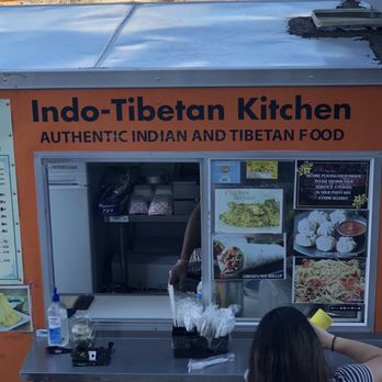 Indo-Tibetan kitchen - a woman ordering food from a vending machine - Food Trucks Near Me Indo-Tibetan kitchen - a woman ordering food from a vending machine - Food Trucks Near Me