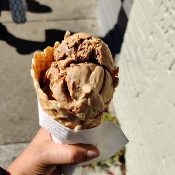 The Fudgery - a hand holding a cone of ice cream - Desserts Near Me - Charleston, South Carolina