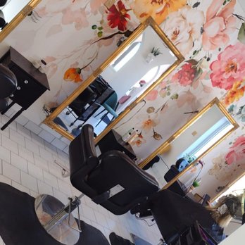 Elle Reve Salon elegant styling area with floral wallpaper and gold mirrors