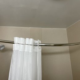 Shower Rod loose and hanging down. No way to keep curtain closed. Water all over the bathroom floor.