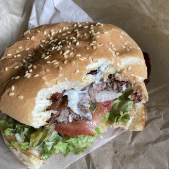 Rain City Burgers - Bacon and Blue Cheese Burger (with a bite or two out so you can see the yummy goodness) - Burgers Near Me - Seattle, Washington Rain City Burgers - Bacon and Blue Cheese Burger (with a bite or two out so you can see the yummy goodness) - Burgers Near Me - Seattle, Washington