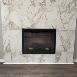 Hunzi Built - Tiled fireplace, new vinyl plank flooring.