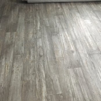CarpetCow - a wooden floor with a roll of paper - Flooring Near Me - East Meadow, New York