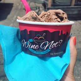 a hand holding a cup of ice cream