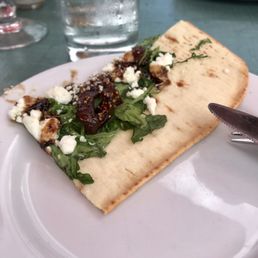 Piece of the fig and goat cheese flatbread Piece of the fig and goat cheese flatbread