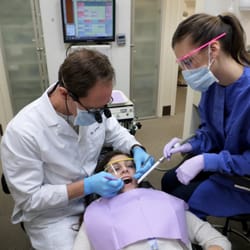 William R Hummer, DDS - Dr. Hummer and Vanessa D.A. giving the patient an oral exam.