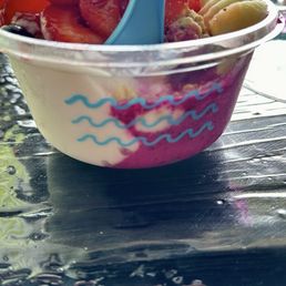 Açaí & coconut  base with bananas, granola, strawberries, blueberries, and honey