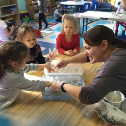 Acorn Academy Preschool - Children explore how insulation changes the feel of cold water