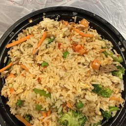 a bowl of rice with broccoli and carrots