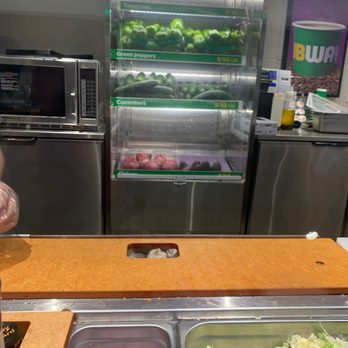 Subway - a man preparing food in a subway kitchen - Sandwiches Near Me - Oakland, California