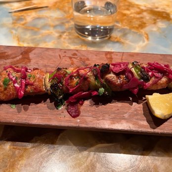 Rigo - PORK BROCHETTA - YUM pork skewers - marinated in garlic, cilantro, cumin, lemon and harissa with pickled purple cabbage - Spanish Near Me - Honolulu, Hawaii Rigo - PORK BROCHETTA - YUM pork skewers - marinated in garlic, cilantro, cumin, lemon and harissa with pickled purple cabbage - Spanish Near Me - Honolulu, Hawaii