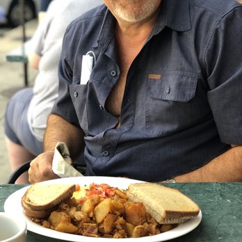 Skippers - a man sitting at a table with a plate of food - New American Near Me - Northport, New York