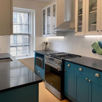 Home by Me - Rainforest Green custom base cabinets, combined with prefabricated glass front cabinets, black granite tops and orange vinyl floor tiles - General Contractors Near Me - Wood-Ridge, New Jersey