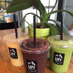 The Local Lift Juice Bar - Delicious smoothies! Green Berry Boogeyman (center) with strawberry, blueberry, orange, banana, spinach.