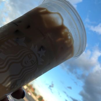 Starbucks - a hand holding a cup of coffee - Coffee & Tea Near Me - Albuquerque, New Mexico