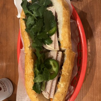 Pho Tran - a sandwich in a basket on a table - Vietnamese Near Me - New Orleans, Louisiana Pho Tran - a sandwich in a basket on a table - Vietnamese Near Me - New Orleans, Louisiana