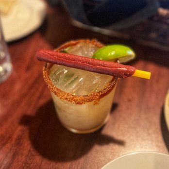 Martyrs - a close up of a drink with a hot stick sticking out of it - Steakhouses Near Me - Taos, New Mexico
