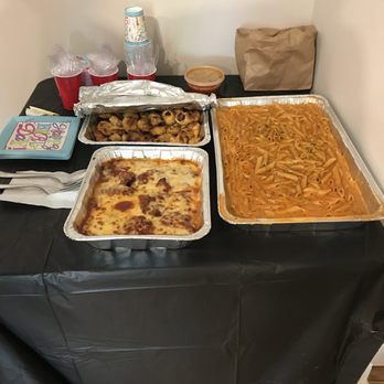 Dino's Pizza - a variety of food on a table - Pizza Near Me - Bronx, New York