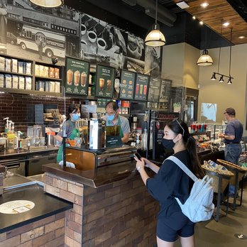 Starbucks - a woman using her cell phone in a coffee shop - Coffee & Tea Near Me - Vancouver, British Columbia Starbucks - a woman using her cell phone in a coffee shop - Coffee & Tea Near Me - Vancouver, British Columbia