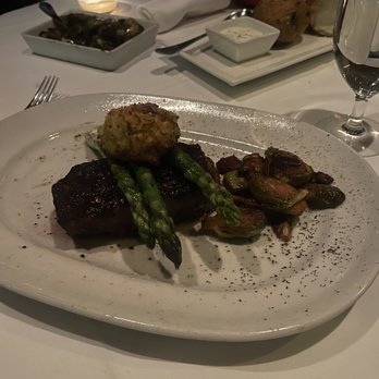 Steak 48 - NY Strip Cooked medium plus w/h crab cake ( Oscar sauce on side) - Steakhouses Near Me - Houston, Texas Steak 48 - NY Strip Cooked medium plus w/h crab cake ( Oscar sauce on side) - Steakhouses Near Me - Houston, Texas