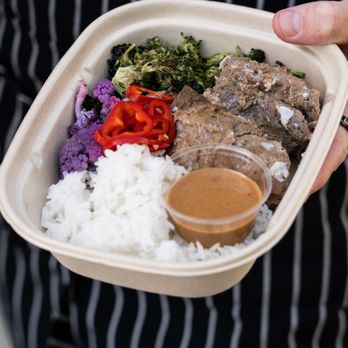 Deeply Nourished - a person holding a container of food - Personal Chefs Near Me - La Jolla, California