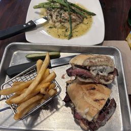 Flat iron steak sandwich and the chicken breast with lemon cream sauce, mashed potatoes, and asparagus Flat iron steak sandwich and the chicken breast with lemon cream sauce, mashed potatoes, and asparagus