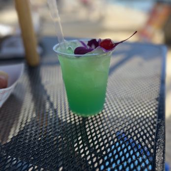 Koa Oasis - a green drink with a cherry garnish - Dive Bars Near Me - Honolulu, Hawaii