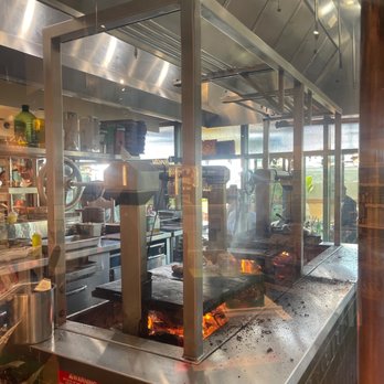 Terra - The kitchen grill with a prepare food - Italian Near Me - Santa Clara, California