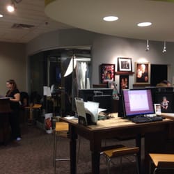 Jcp Portraits - Studio includes one of two photo areas in the background, cashier on the left, and computers for reviewing photos.