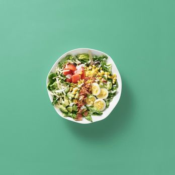 Freshii - a bowl of salad on a green background - Salad Near Me - Calgary, Alberta Freshii - a bowl of salad on a green background - Salad Near Me - Calgary, Alberta