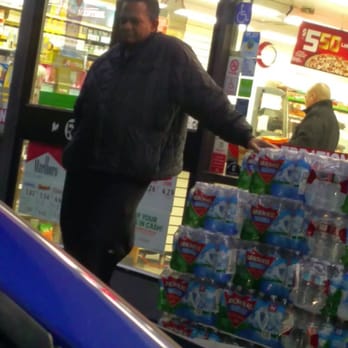 7-Eleven - a man standing in front of a store - Convenience Stores Near Me - Los Angeles, California