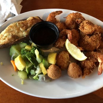 Pompano Joe's - Coconut shrimp with a twice baked potato, vegetable medley, and hush puppies - Seafood Near Me - Destin, Florida Pompano Joe's - Coconut shrimp with a twice baked potato, vegetable medley, and hush puppies - Seafood Near Me - Destin, Florida