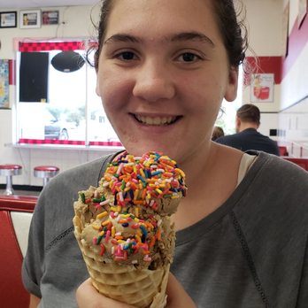 Papa Clyde's Too - a woman holding a cone of ice cream with sprinkles - Ice Cream & Frozen Yogurt Near Me - Spring Hill, Florida Papa Clyde's Too - a woman holding a cone of ice cream with sprinkles - Ice Cream & Frozen Yogurt Near Me - Spring Hill, Florida