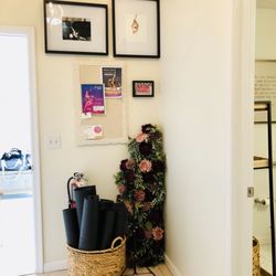 Twisted Aerial Fitness - Yoga mat storage, studio events board, inspirational photos, door to the restroom