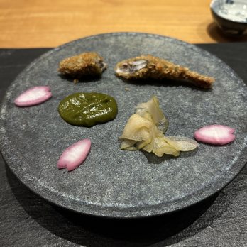 UKA - Bonus course in the middle of the meal: small fried whole fish. The thing that looks like ginger is thin slices of pickled apple. - Japanese Near Me - Los Angeles, California