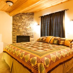 Mimi's Lodges | Papa Bear Lodge - Lone Peak bedroom, featuring a gas fireplace and a soaking tub in the bedroom. Timpanogos bedroom also has a gas fireplace and soaking tub.
