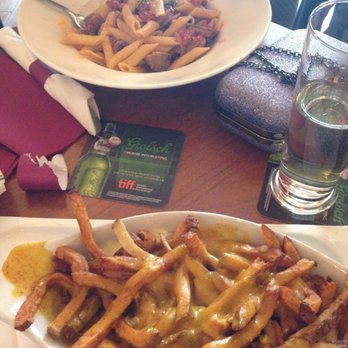 Sin And Redemption - Indian style poutine (belgian frites with curry sauce and cheese curds) - Pubs Near Me - Toronto, Ontario