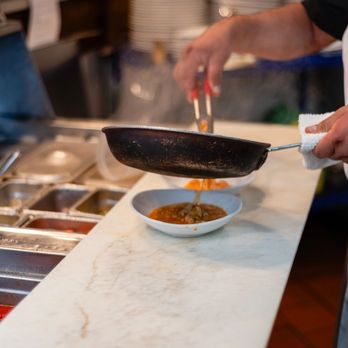 Trattoria Appia - a chef preparing food in a kitchen - Italian Near Me - Providence, Rhode Island Trattoria Appia - a chef preparing food in a kitchen - Italian Near Me - Providence, Rhode Island