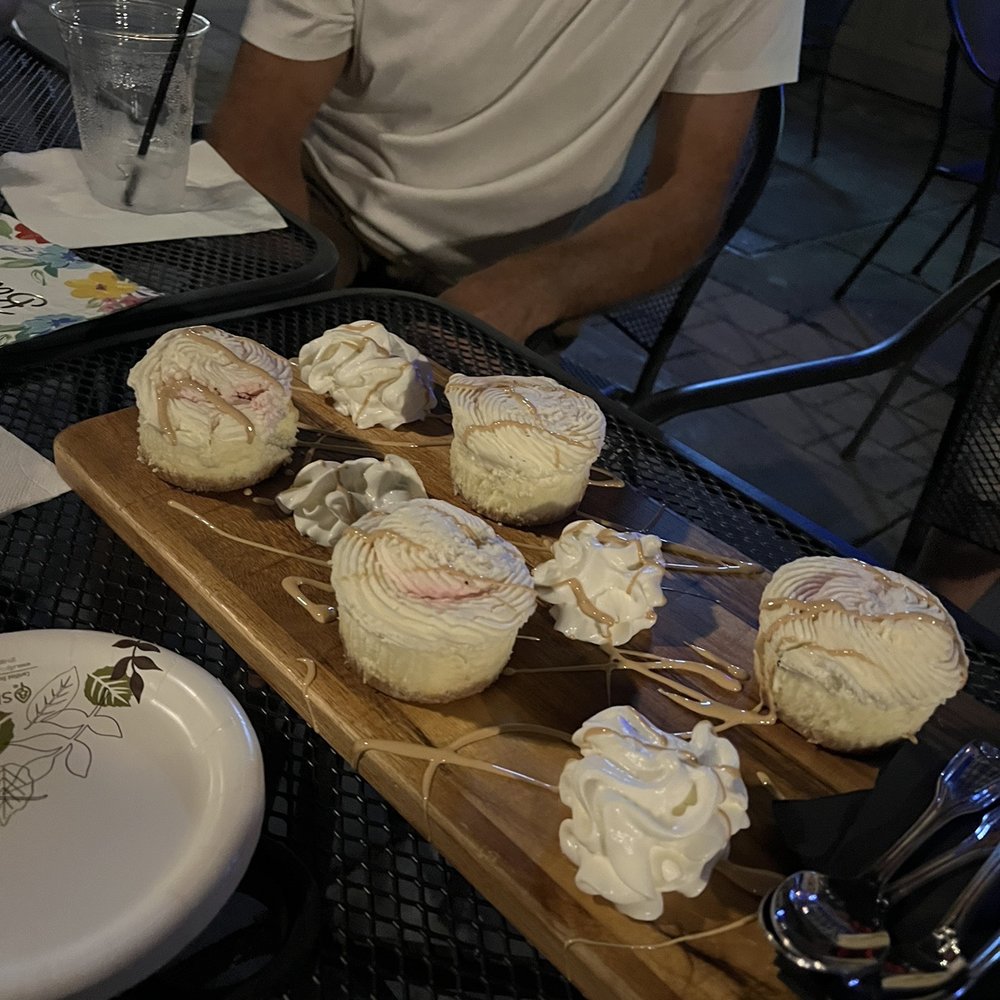 Orbis Lounge - a man sitting at a table with cupcakes - Lounges Near Me - Syracuse, New York Orbis Lounge - a man sitting at a table with cupcakes - Lounges Near Me - Syracuse, New York
