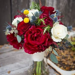 Always In Bloom Florist Gifts - Custom bridal bouquet using burgundy peonies, white roses, blue thistle and yellow billy balls - accented with a hint of Rosemary!