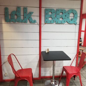 Idk BBQ - Entry area table and sign.  I.D.K. stands for:  I Don't Know. - Barbeque Near Me - Tropic, Utah