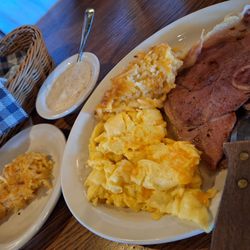 A Country Boy breakfast w/ Country Ham and scrambled eggs with Colby Jack cheese and two sides of hash brown casserole w biscuits and gravy.