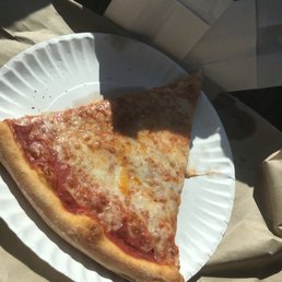 a slice of pizza on a paper plate