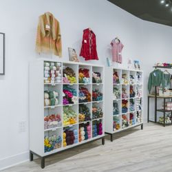 AriYARN Shop and Studio - Vibrant yarn cubbies and handmade knitwear greet customers inside AriYARN's bright and welcoming Park Ridge, IL store.